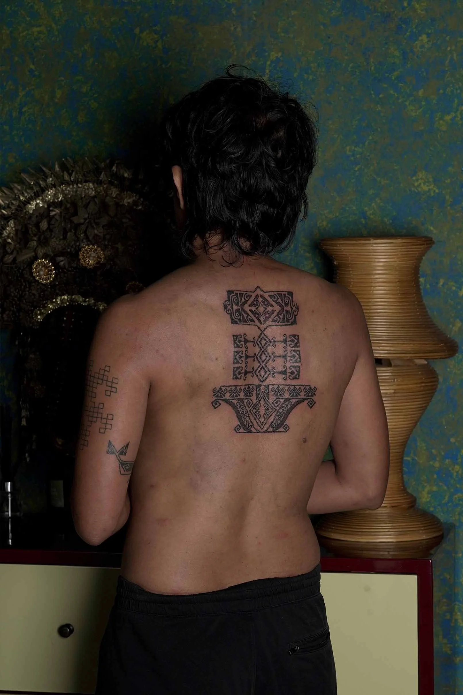 sunflower tattoo using ornament style on man's back