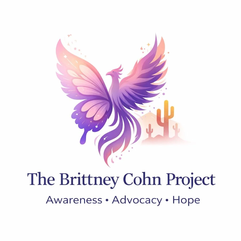A purple and pink stylized phoenix with outstretched wings, set against a desert scene with cacti. Below, the text reads 'The Brittney Cohn Project' with the subtitle 'Awareness ・ Advocacy ・ Hope'.