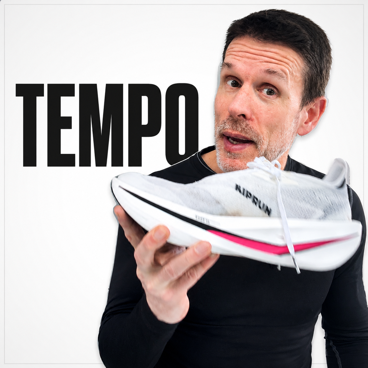 A man holding a white athletic shoe with black and pink accents, standing in front of a white background with the word 'TEMPO' in large black letters.