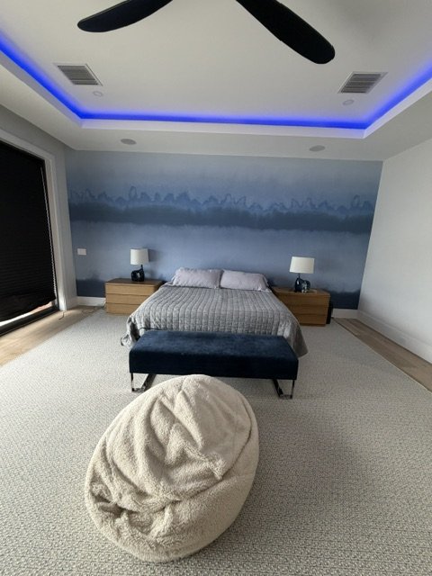Custom blue mural installed in a primary bedroom