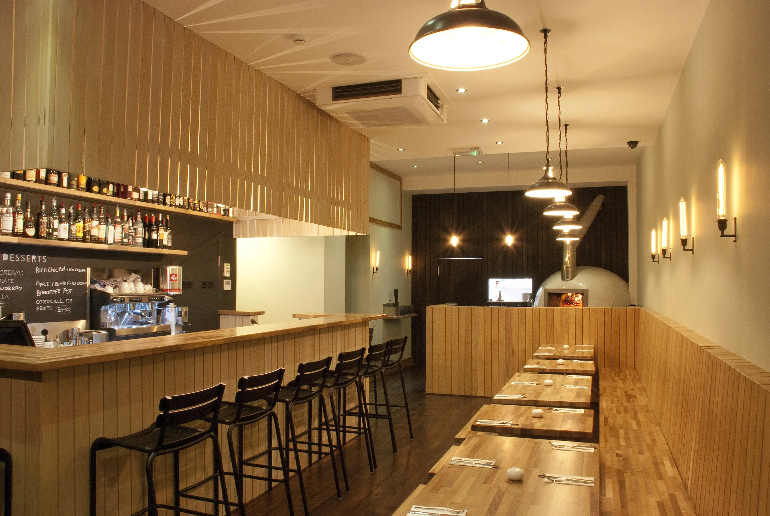 Timber bar interior at The Honest Italian pizza restaurant in Balham