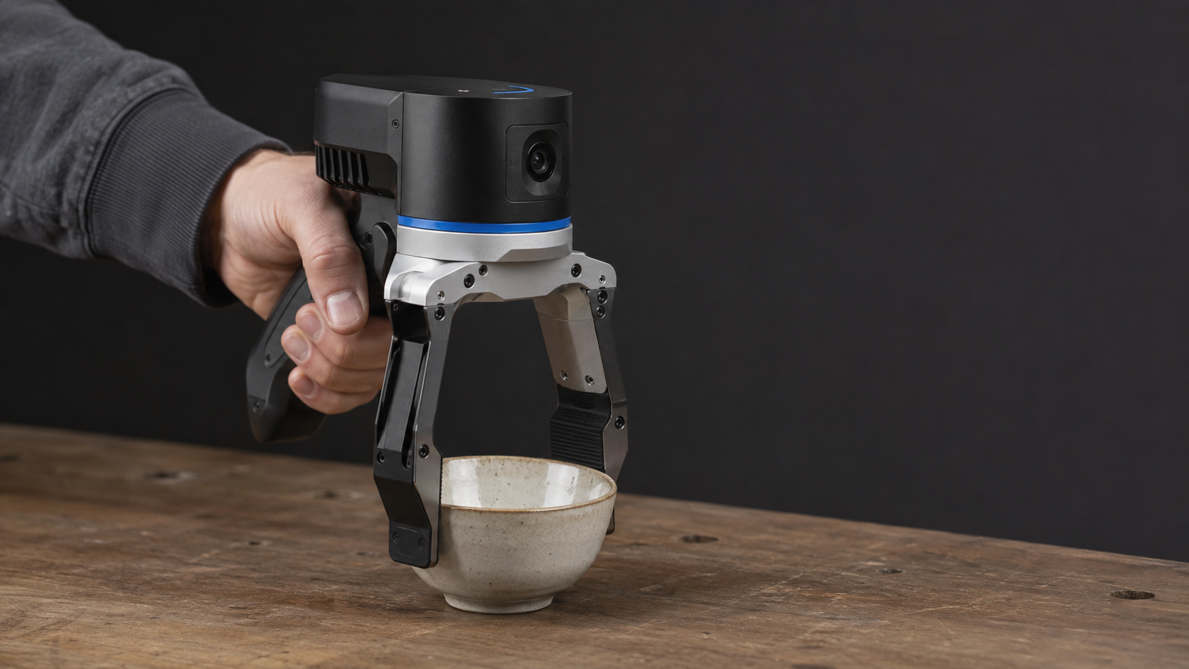 UMI 90D monocular data-capture gripper recording a human manipulation demonstration.