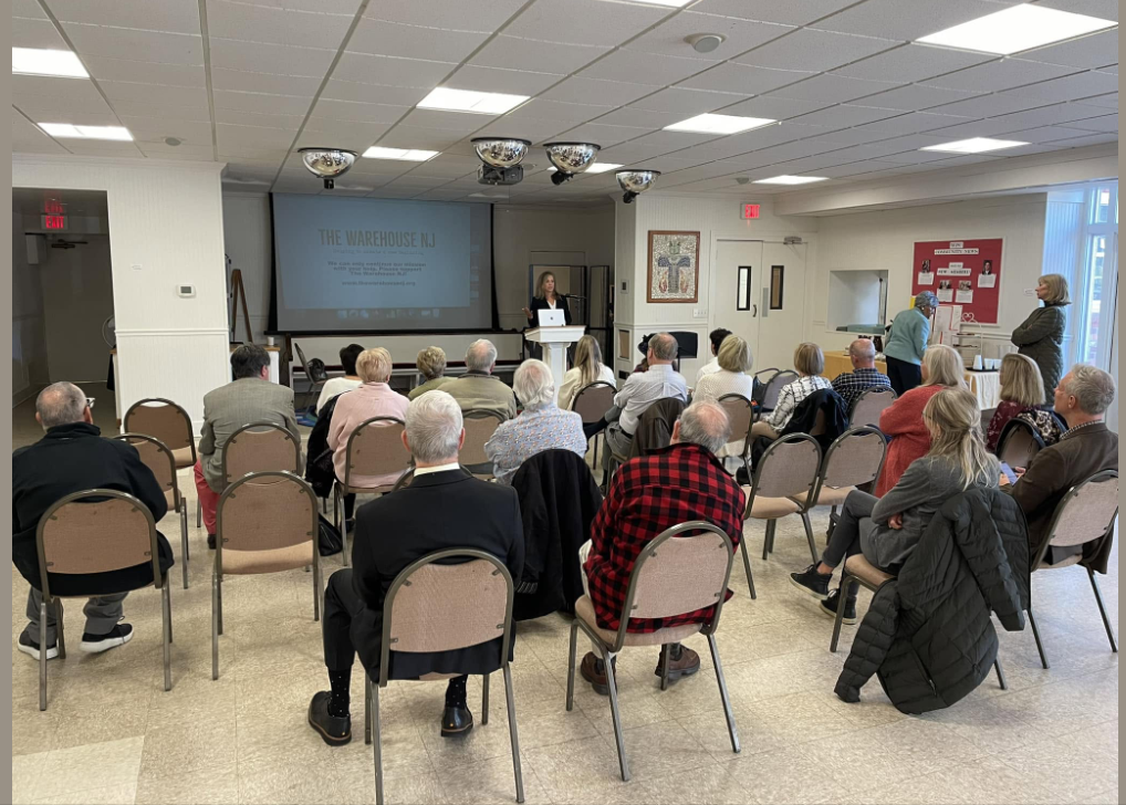Attendees listen to a presentation about The Warehouse NJ during a learning session.