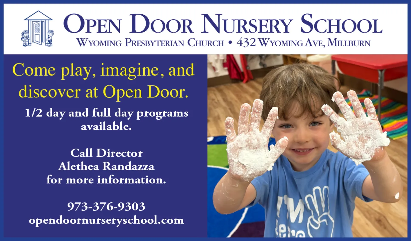 Flyer for Open Door Nursery School with a smiling boy with chalk or paint on his hands, holding up both hands, indoors classroom setting.