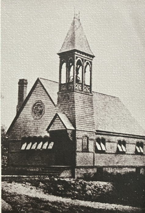 Black and white photo of the historic Wyoming Presbyterian Church with a tall steeple, arched windows, and brick exterior.
