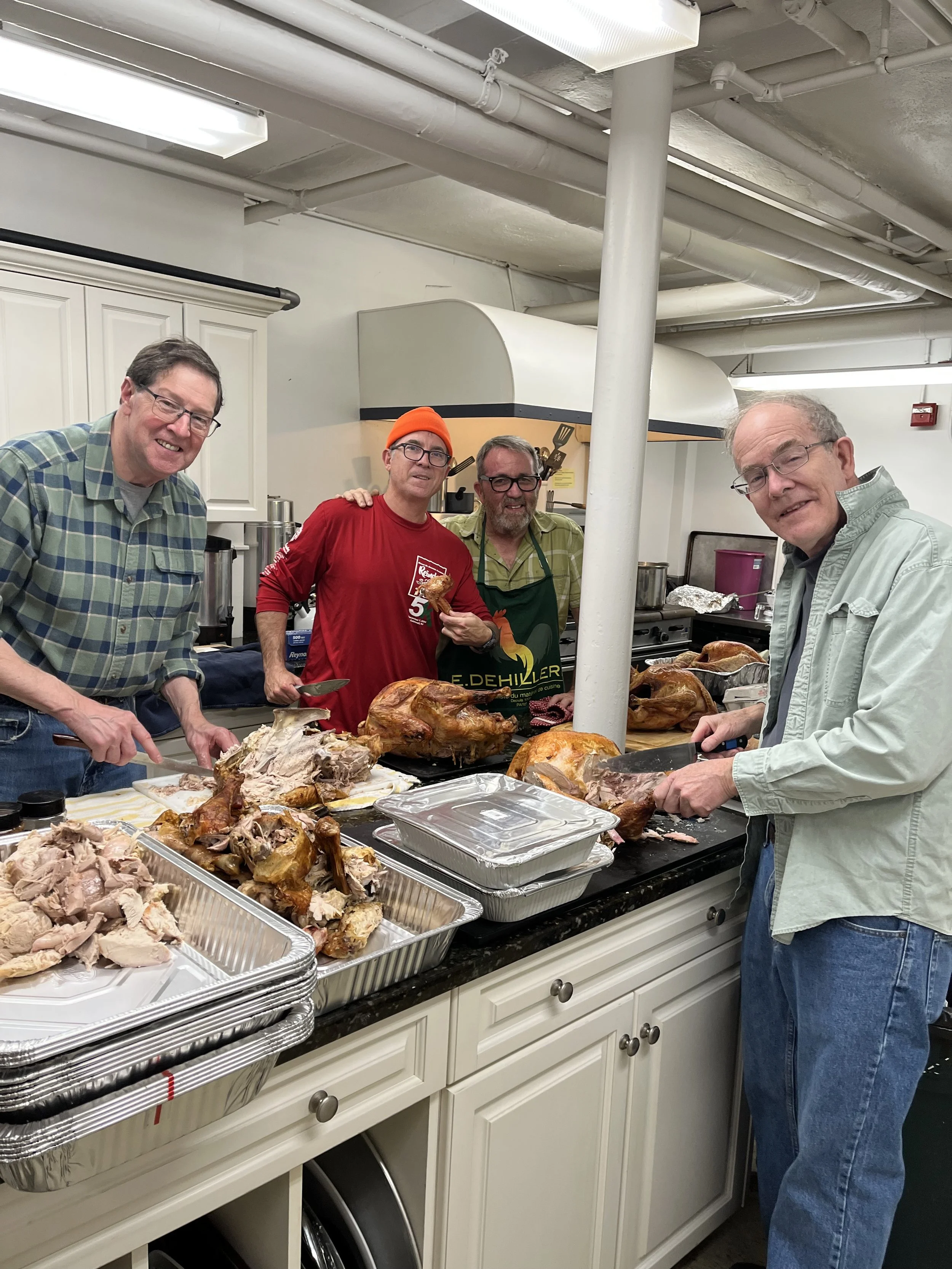 Four men in Wyoming Church kitchen preparing Thanksgiving dinner for those in need at the House of Mercy Mission