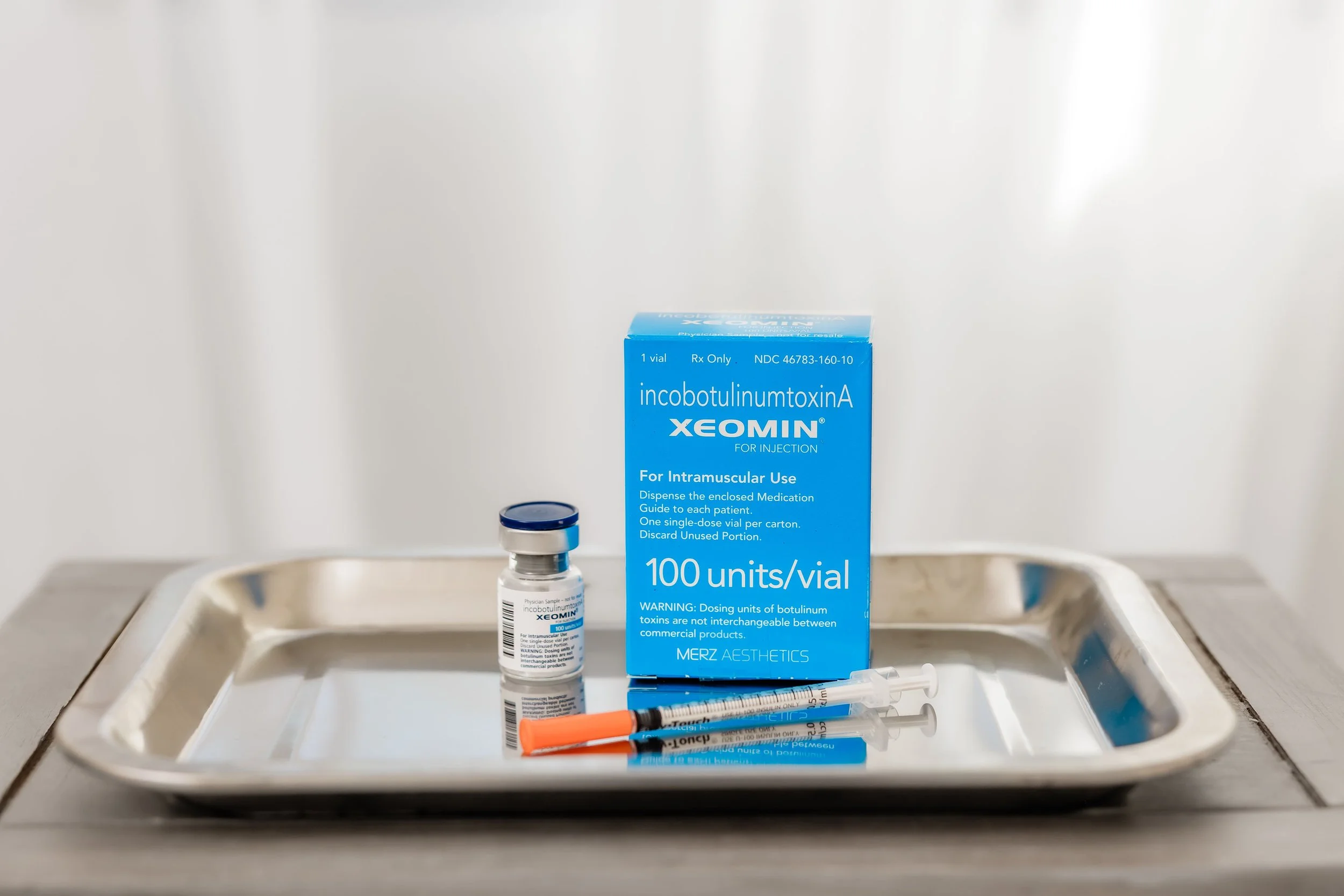 Xeomin wrinkle relaxer vial and injection supplies for aesthetic treatments.