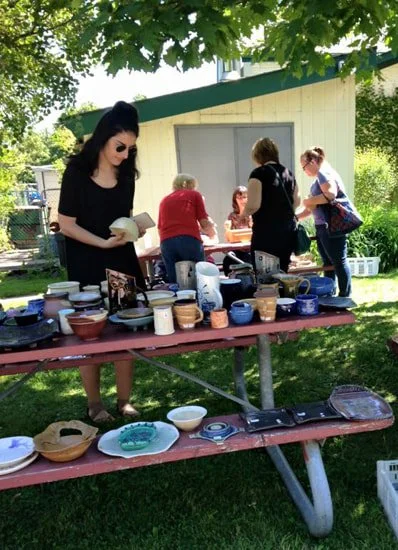 Pottery seconds are for sale on picnic tables