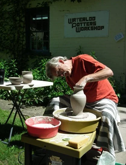 Jason L'Abbé demonstrates throwing pots on the pottery wheel.