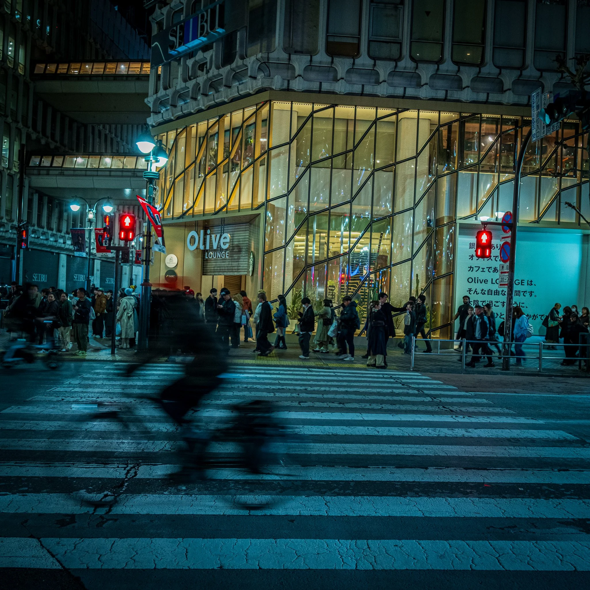 Blurred bicycle crossing through Shibuya crossing in tokyo Japan