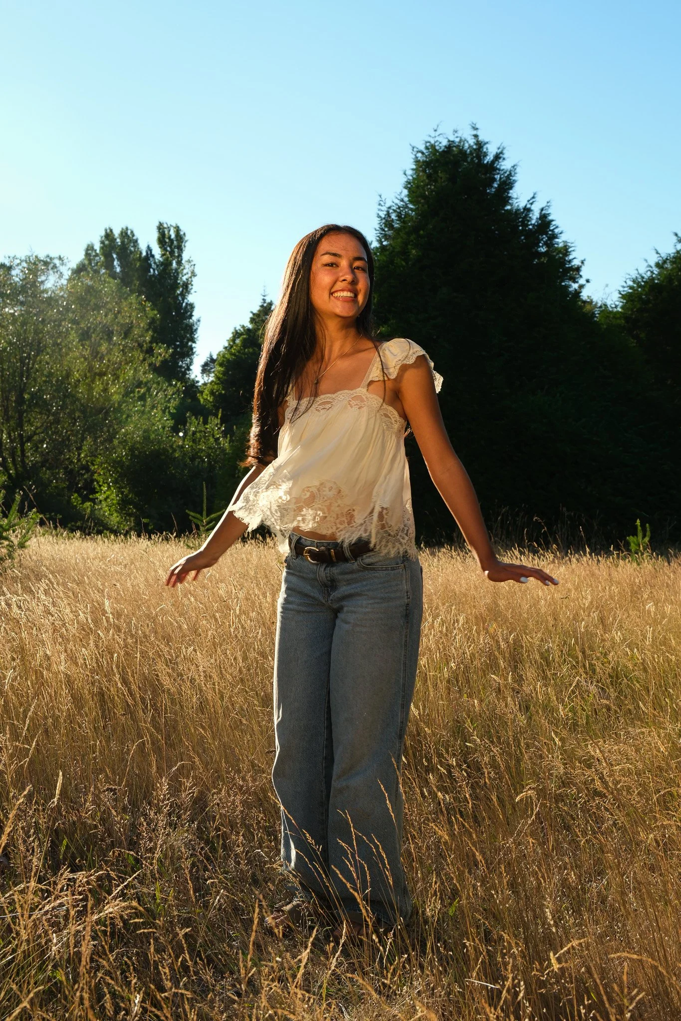 Girl with long hair, twirling in a Senior Portrait, Discovery Park