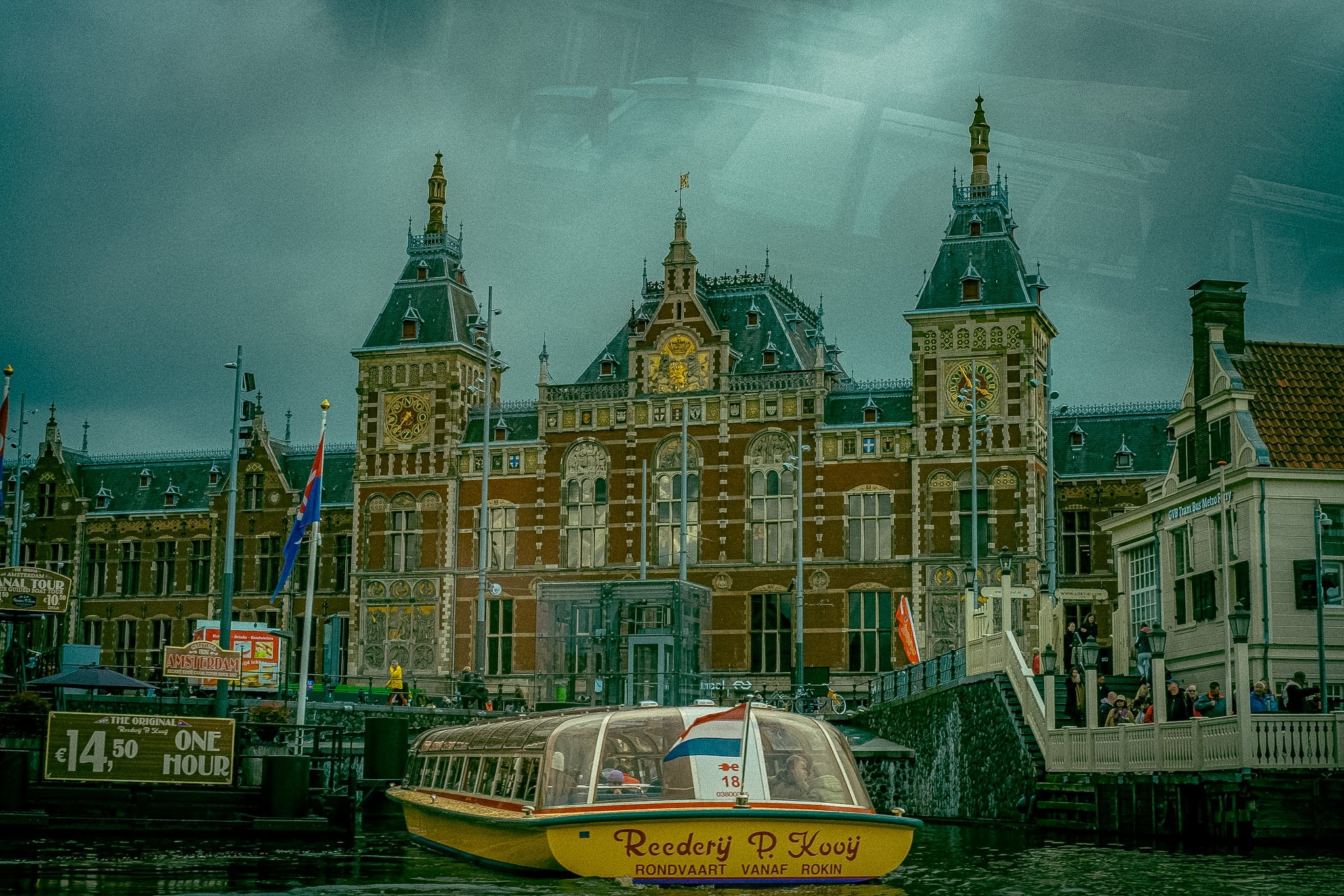 Canal boat in Amsterdam in front the train station The Netherlands 