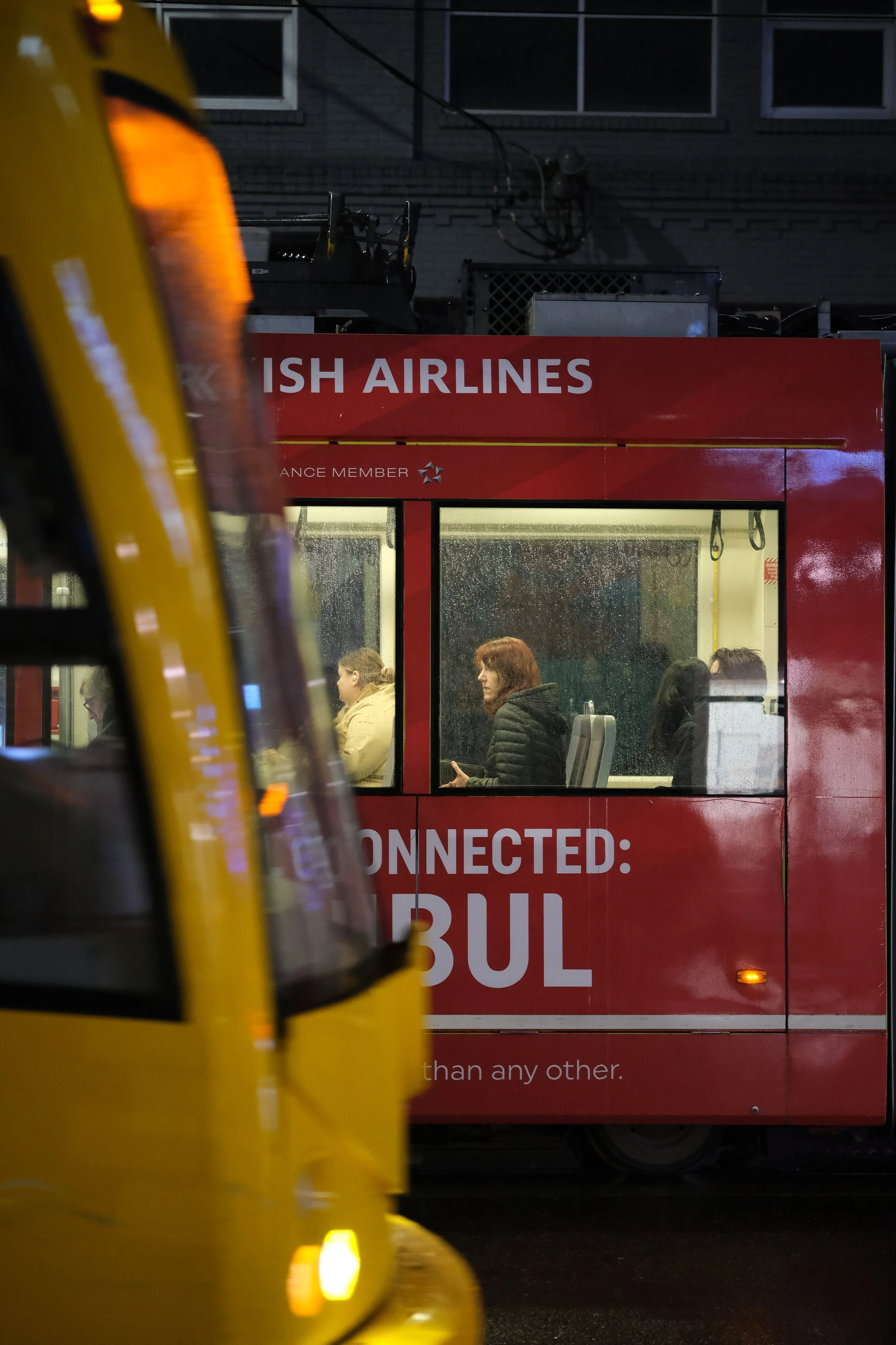 Photo of a women while two trains cross in Seattle Washington 