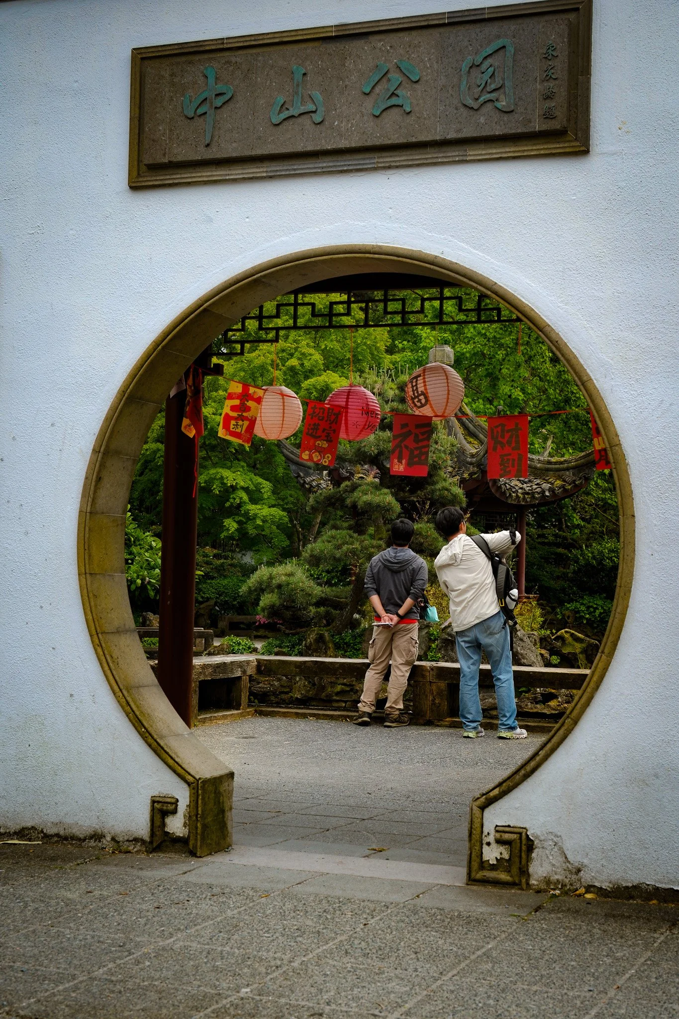 two men looking at flowers in Chinese Gardens, Vancouver BC