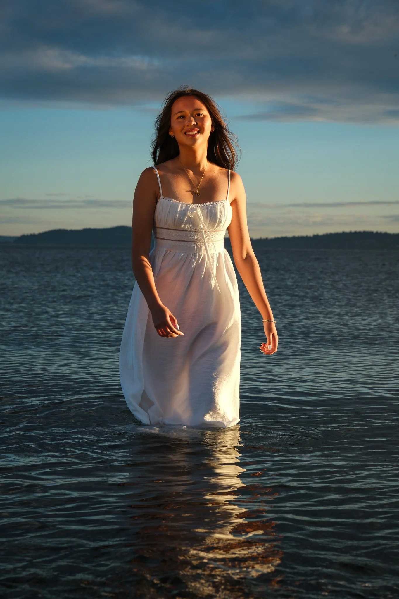 Senior portrait of girl in the Puget Sound in white dress in Seattle Washington 