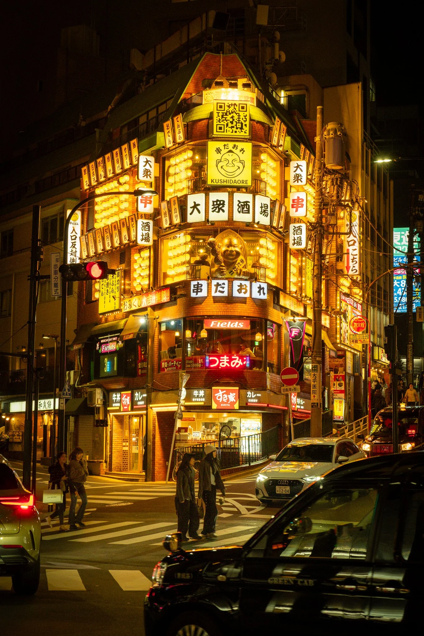 Two people crossing the street in Tokyo Japan 