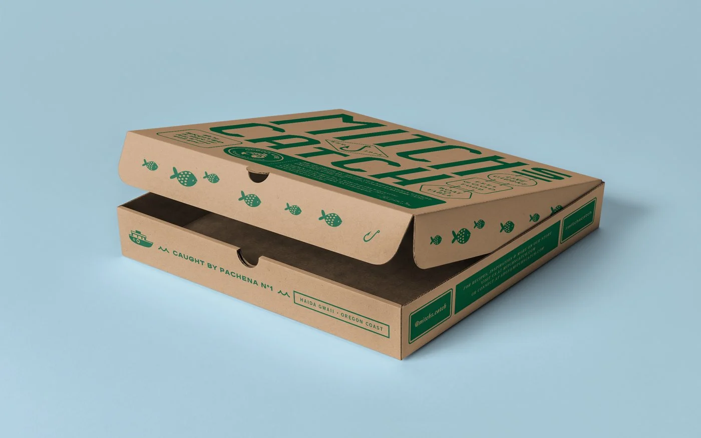 A closed pizza box with green fish and fishing hook illustrations on a rustic brown surface, set against a light blue background.