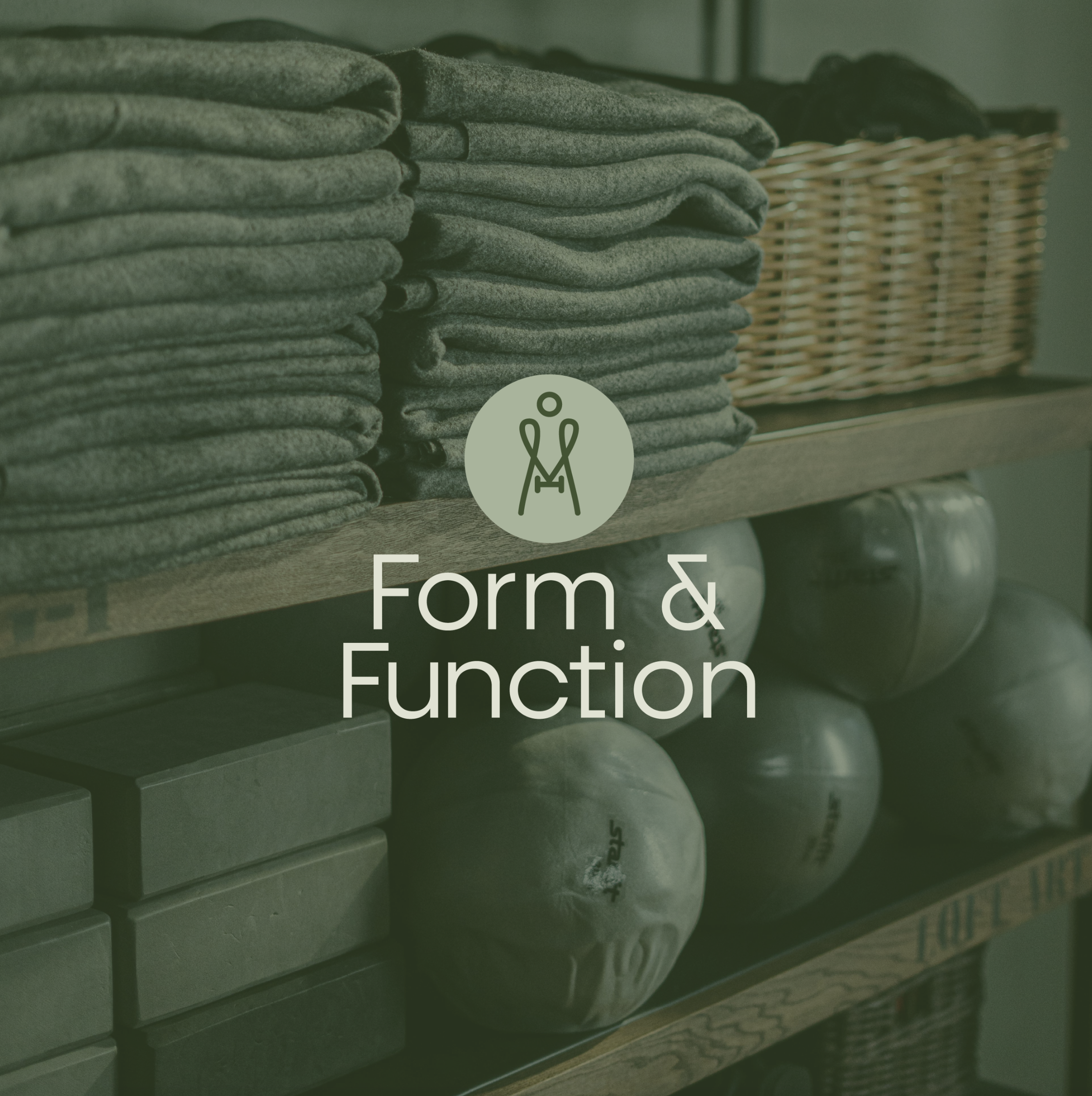 Stacks of folded gray fabric or clothing items on a shelf with a woven basket in the background.