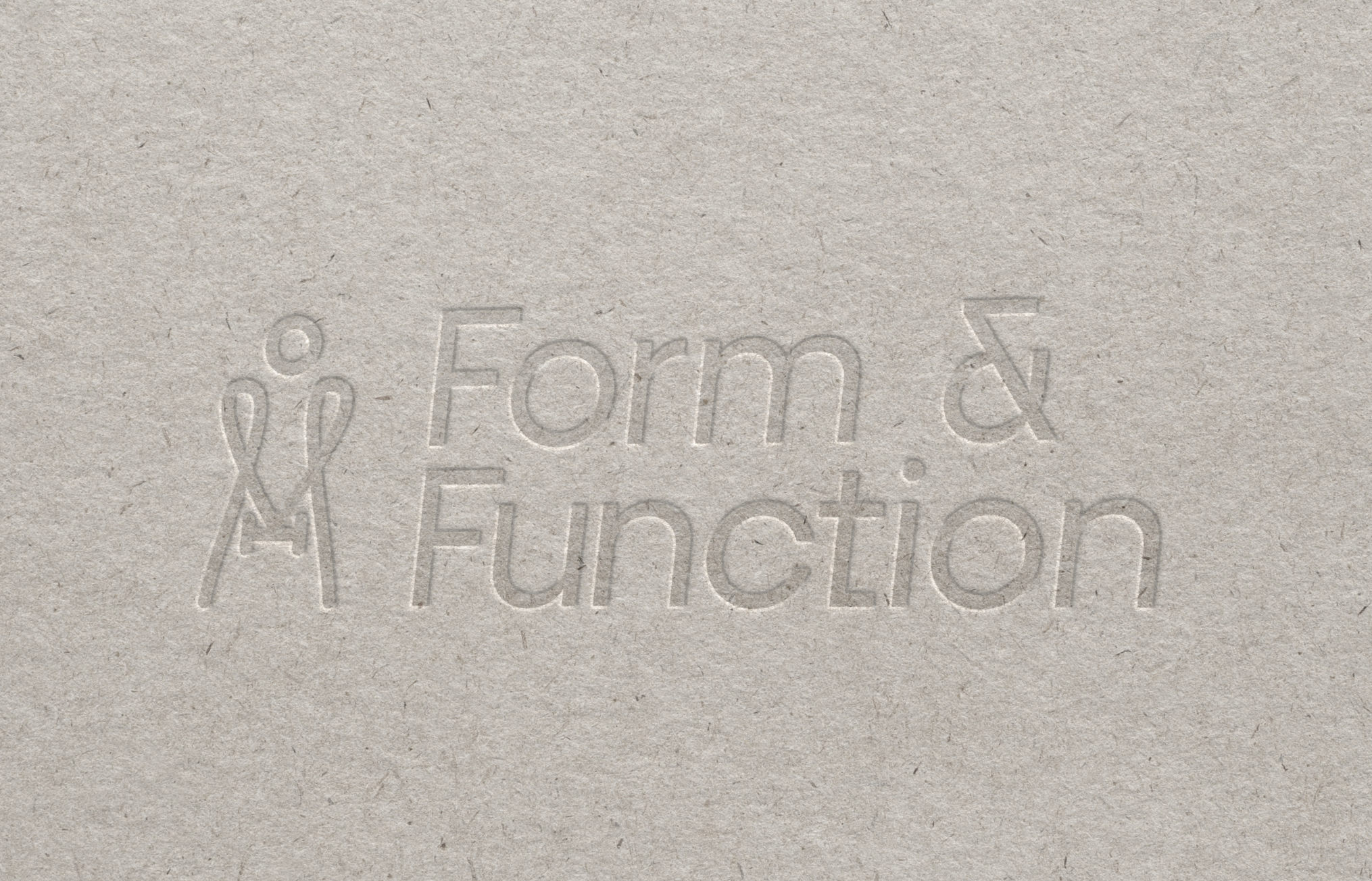 Embossed text on paper surface with phrases 'Form & Education' and a stylized light bulb icon.