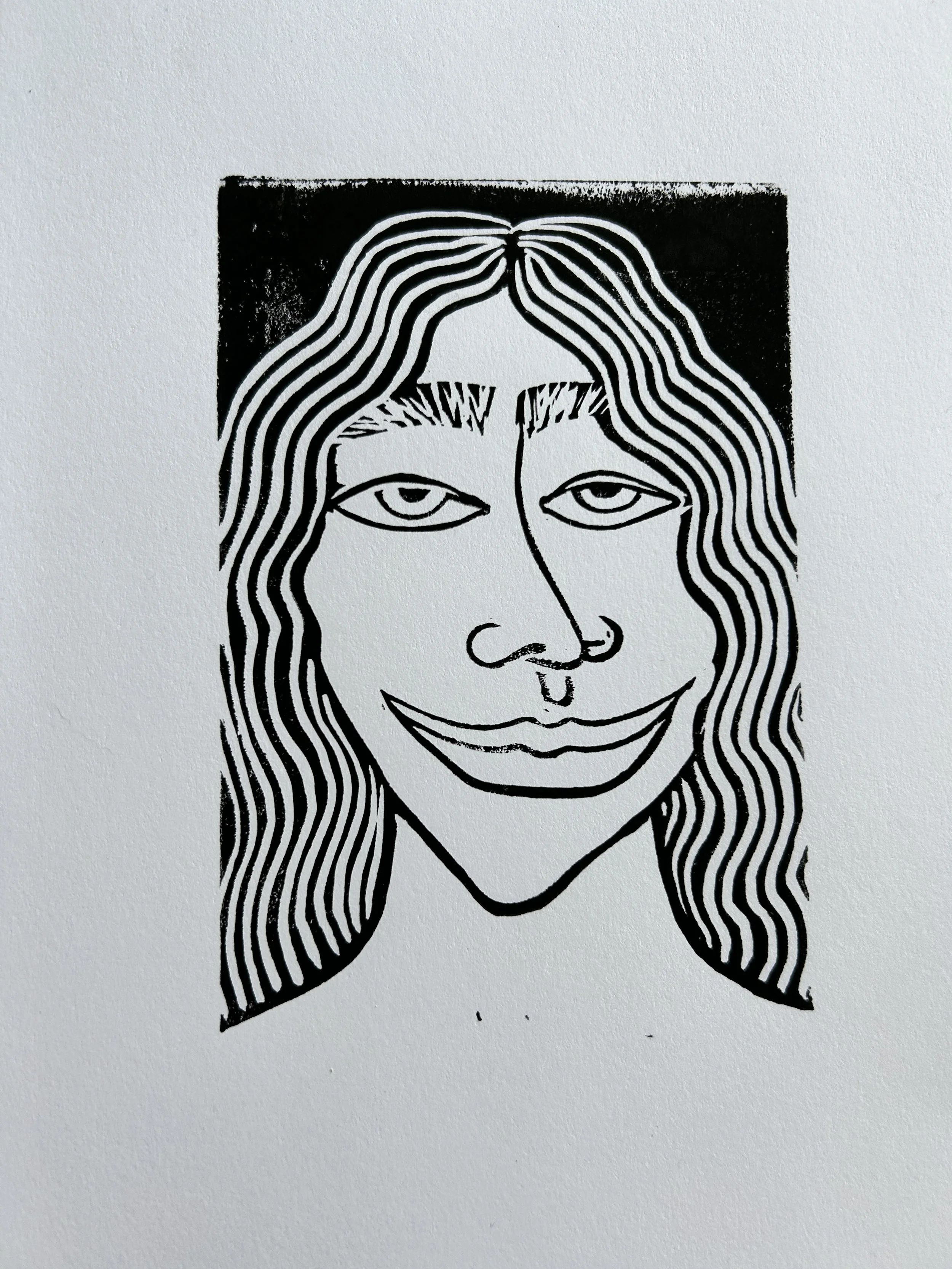 Black and white line drawing of a woman's face with long wavy hair, smiling, set against a black square background.
