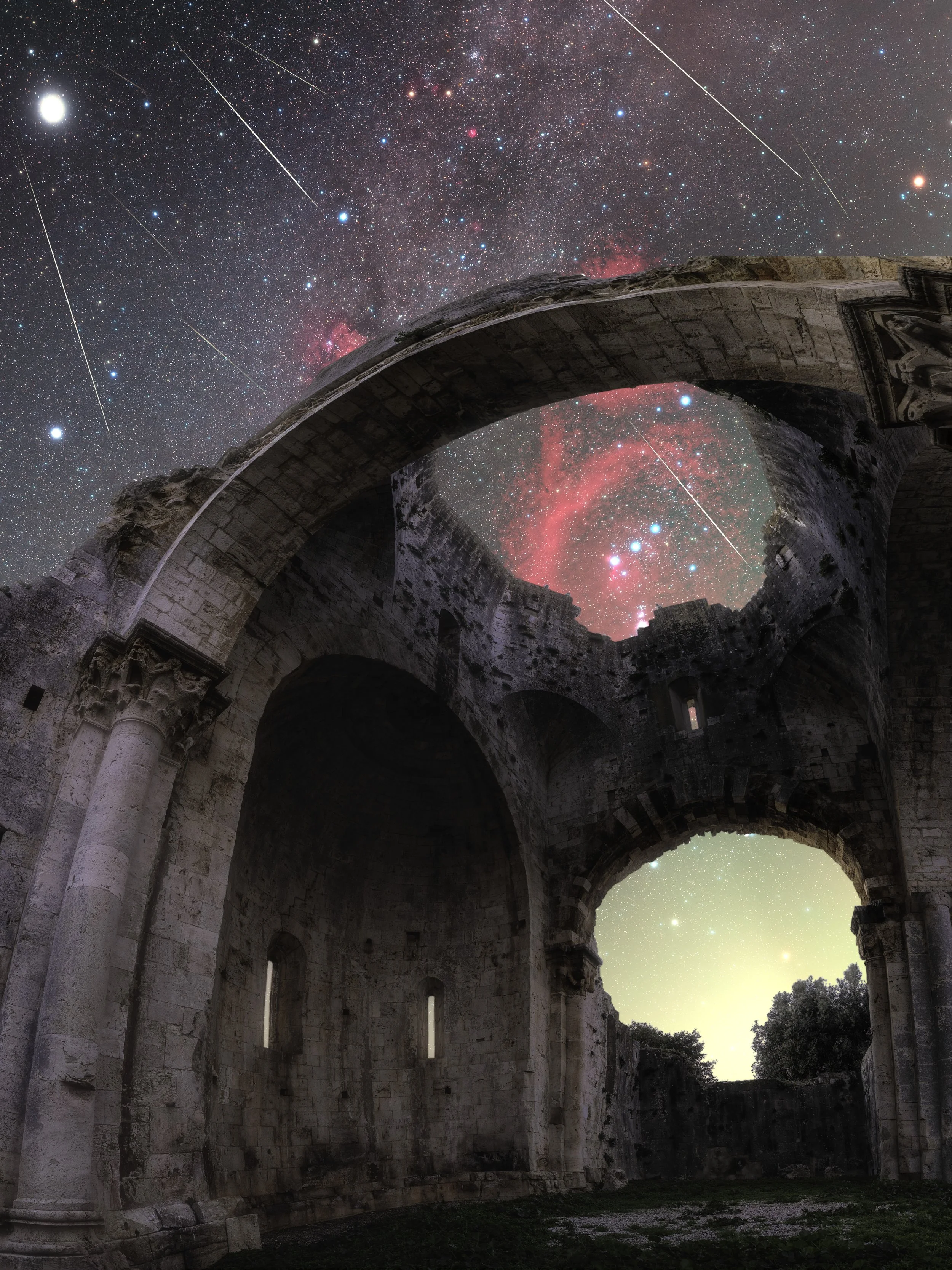 An arch of an ancient stone ruin with a star-filled night sky, including planets and shooting stars, visible through and above the arch.