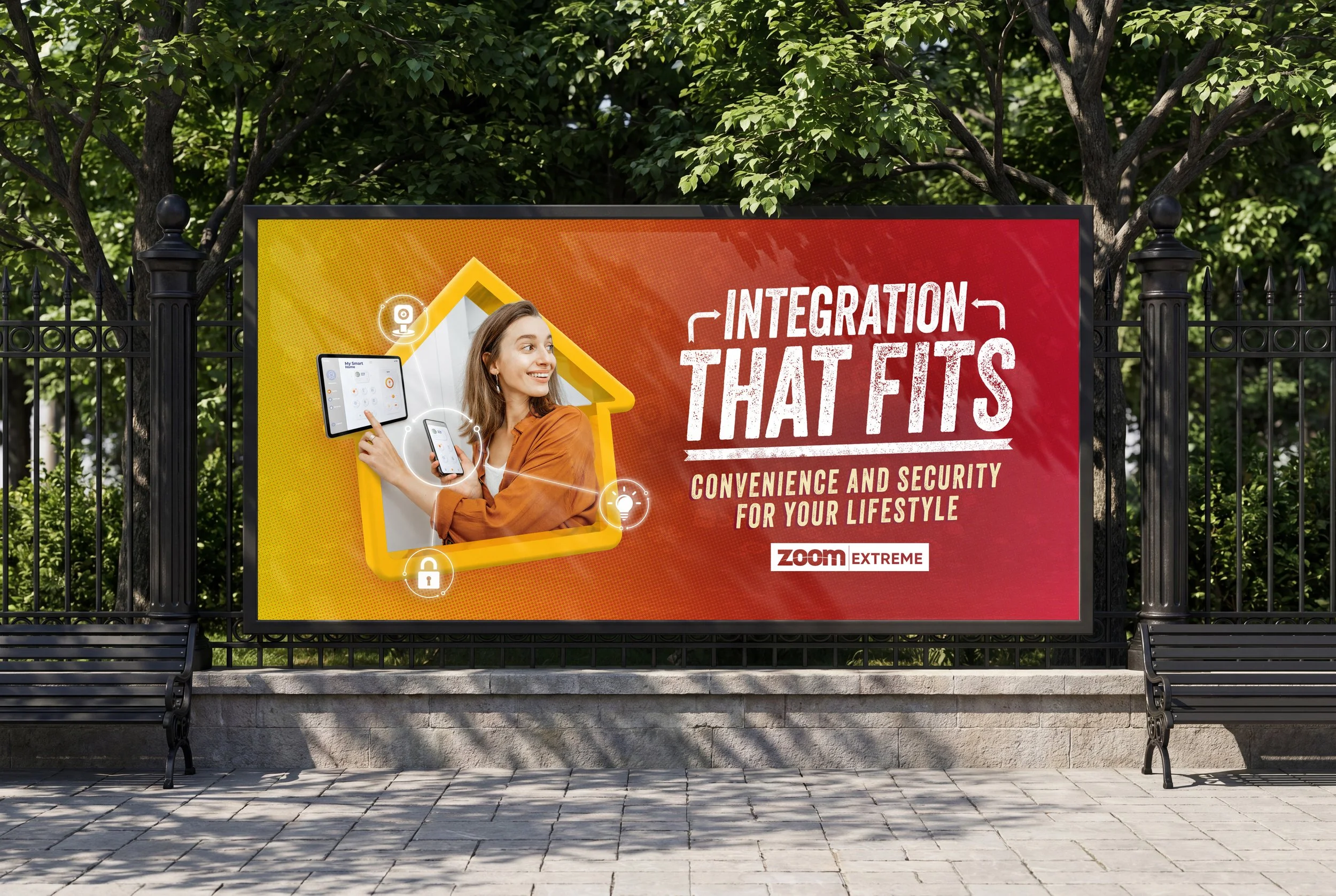 Billboard advertisement for a product called Zoom Extreme emphasizing integration, convenience, and security for lifestyle, featuring a smiling woman holding a smartphone and a tablet with icons of a lock and a light bulb, set outdoors with trees and a black metal fence in the background.