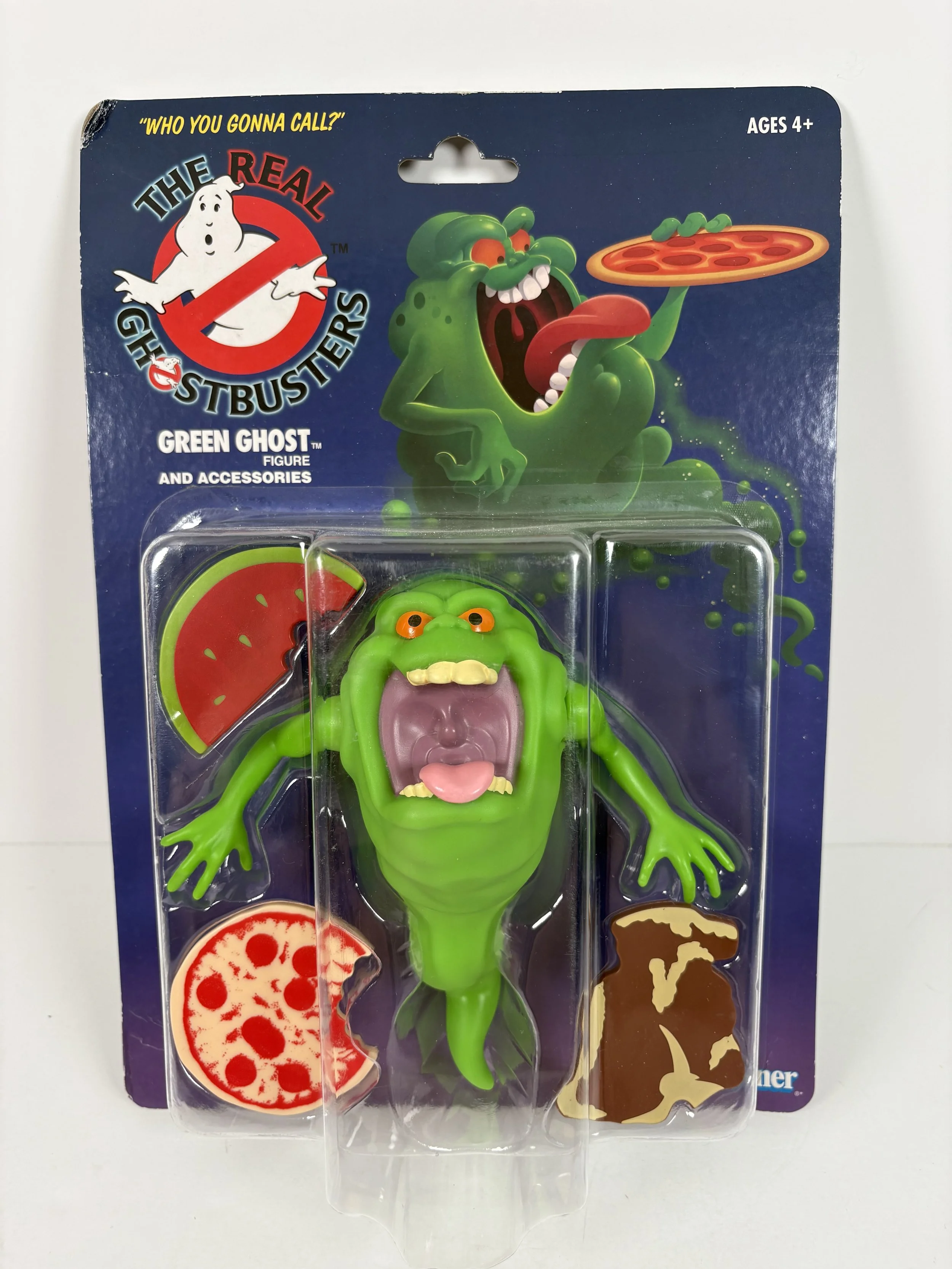 A Green Ghost figure from Ghostbusters with accessories including slice of pepperoni pizza, pizza crust with toppings, and a brown ghost shape.