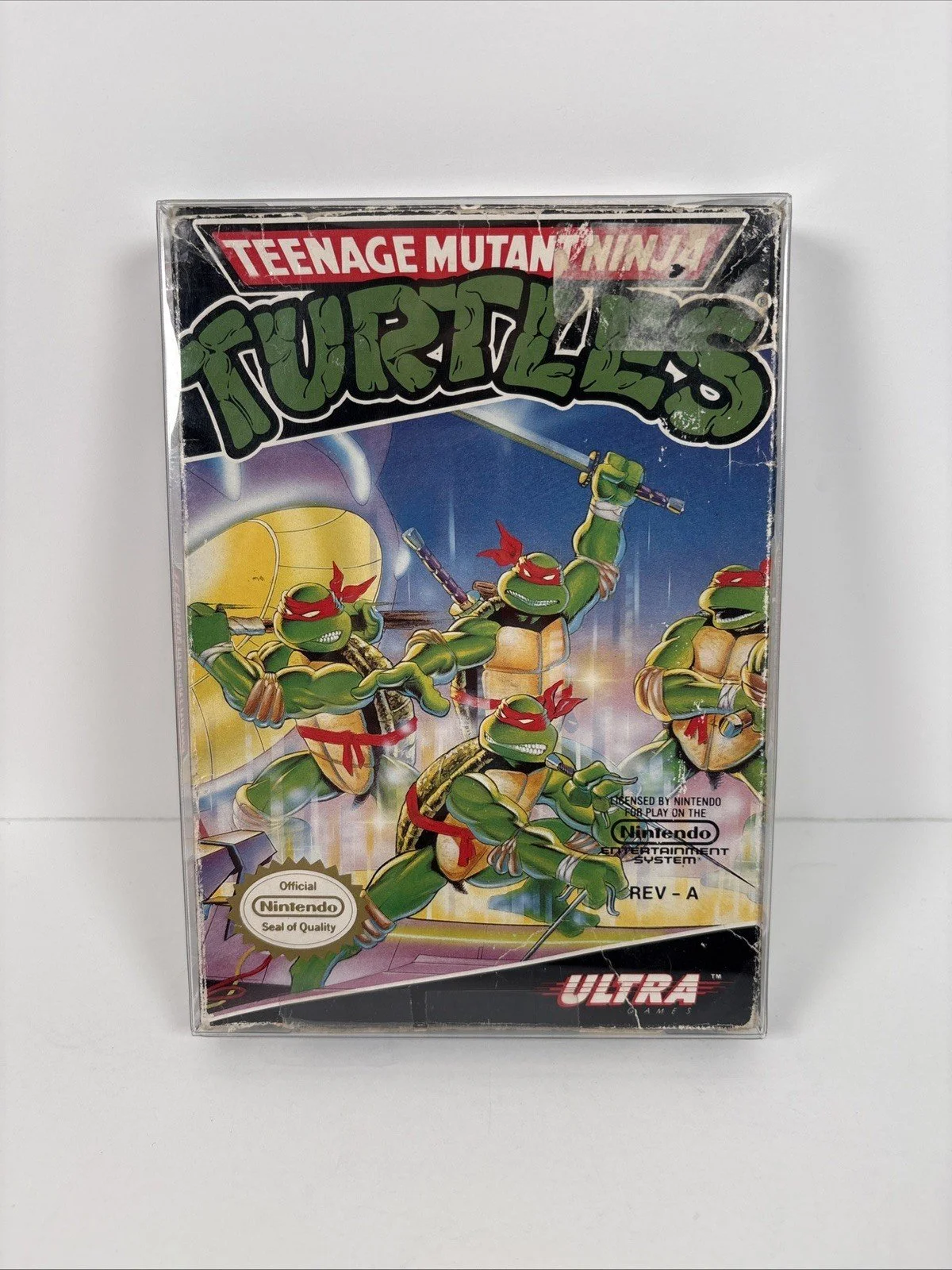 The image shows a sealed Nintendo Teenage Mutant Ninja Turtles video game box featuring the four turtles in combat-ready poses, holding weapons. The background appears to be a sewer setting, consistent with the Teenage Mutant Ninja Turtles theme. The box displays the Nintendo Seal of Quality and the Ultra Games logo at the bottom.