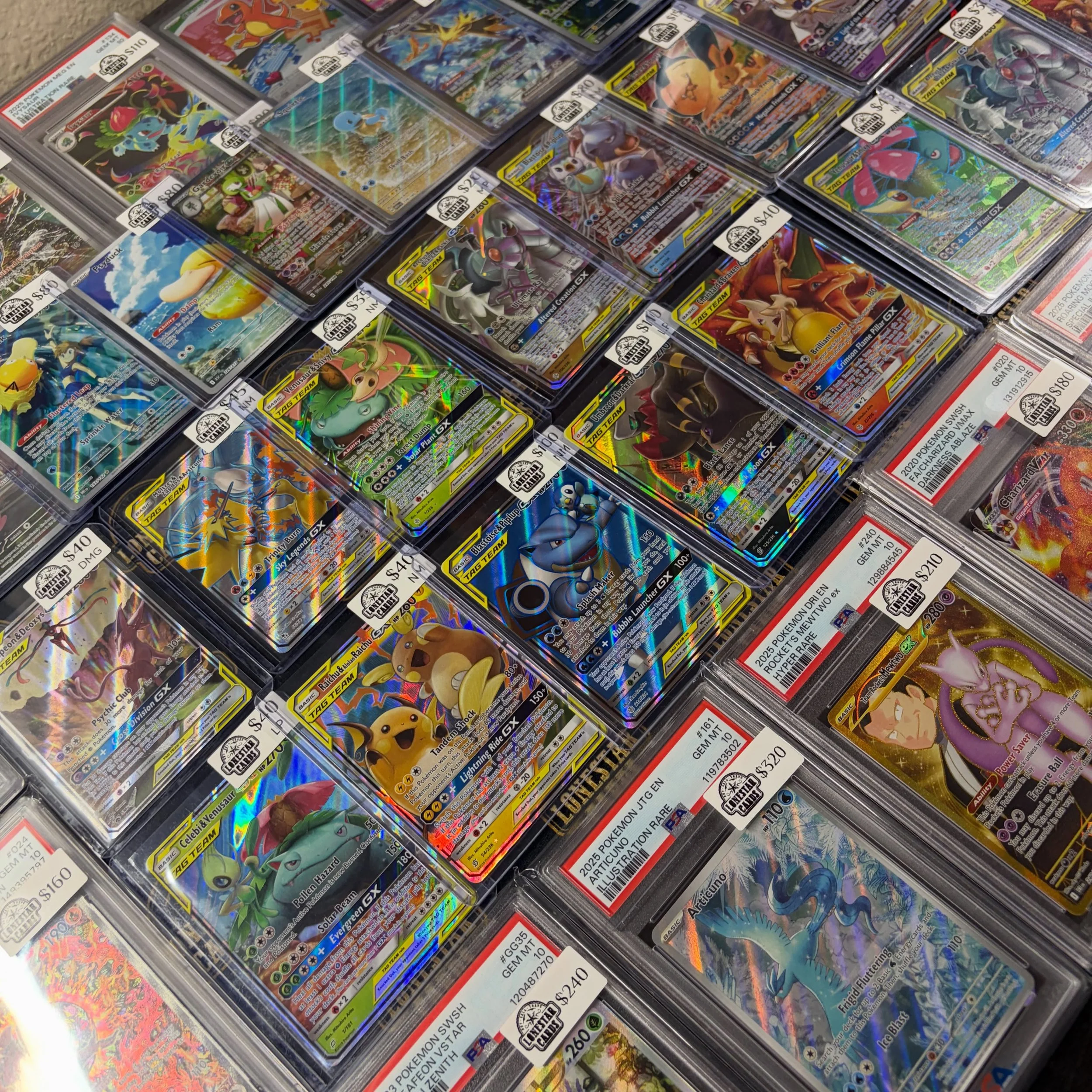 A display of sealed Pokémon trading cards in plastic cases, arranged in rows on a store shelf, featuring various Pokémon characters.