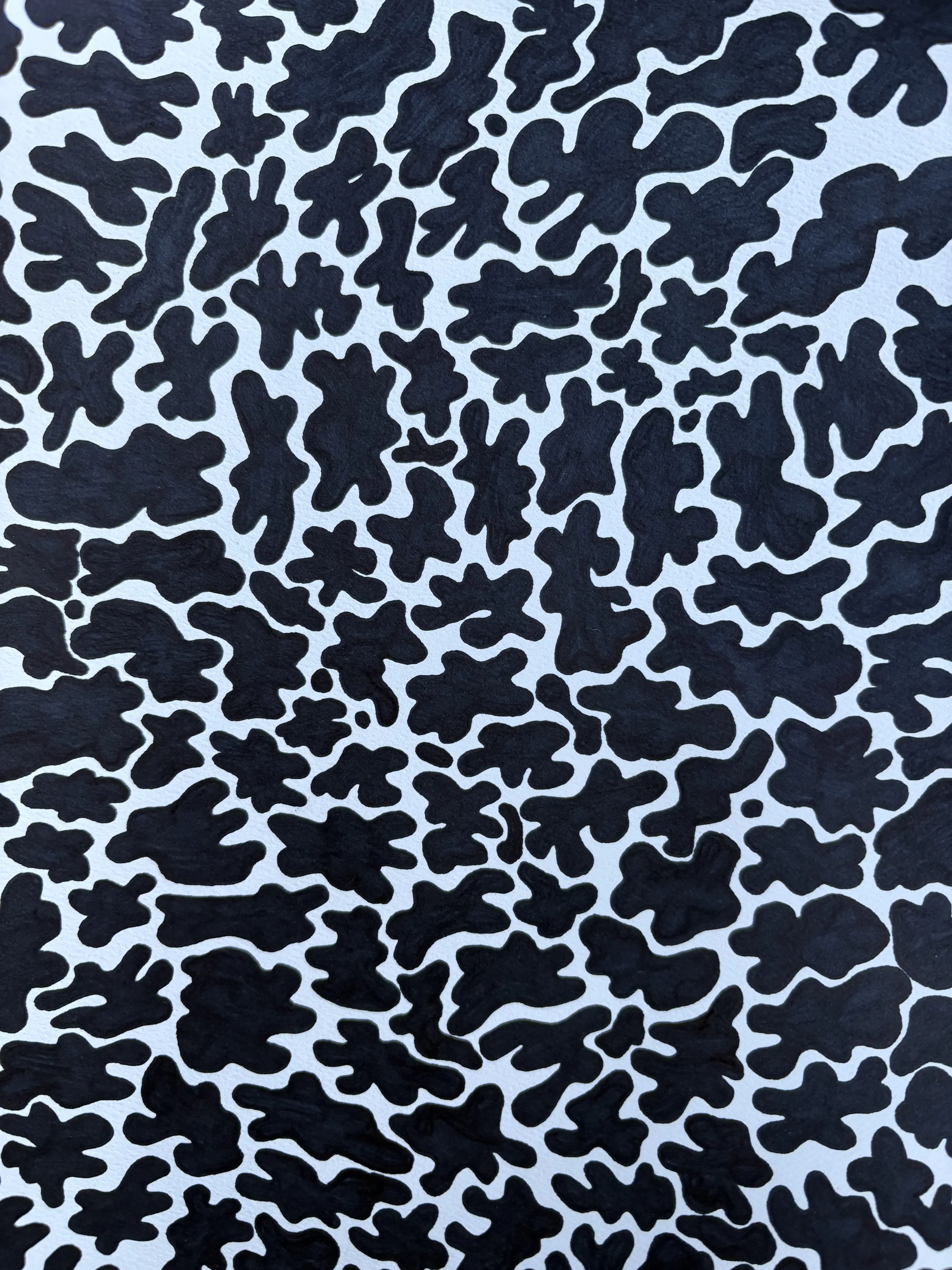 Black irregular shapes on a white background creating a camouflage-like pattern.