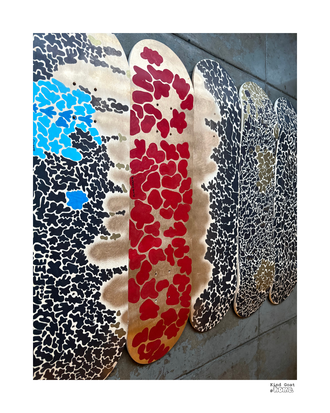 Decorative wooden panels with jungle animal patterns in black, red, blue, and brown colors, displayed on the floor.