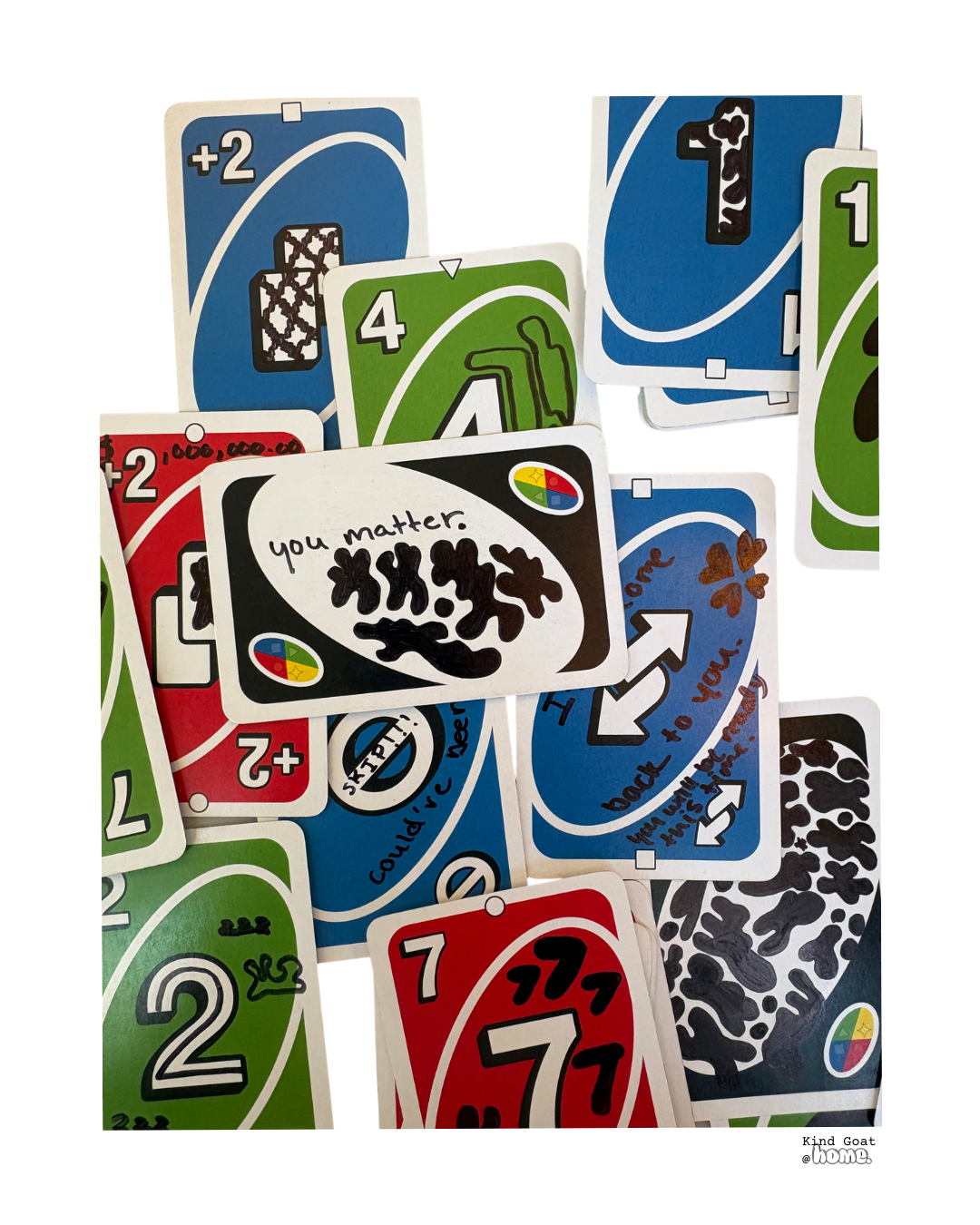 A collection of colorful Uno cards scattered, featuring various numbers and special action symbols, with one card that has handwritten text reading 'you matter.'
