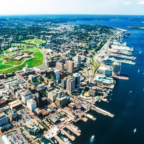Aerial view of downtown Halifax skyline and waterfront along the harbor under a clear sky in Nova Scotia, Canada.