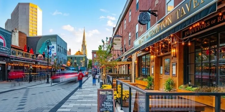 Street view of Argyle Street in downtown Halifax featuring outdoor patio dining, historic storefronts, and vibrant nightlife in Nova Scotia.