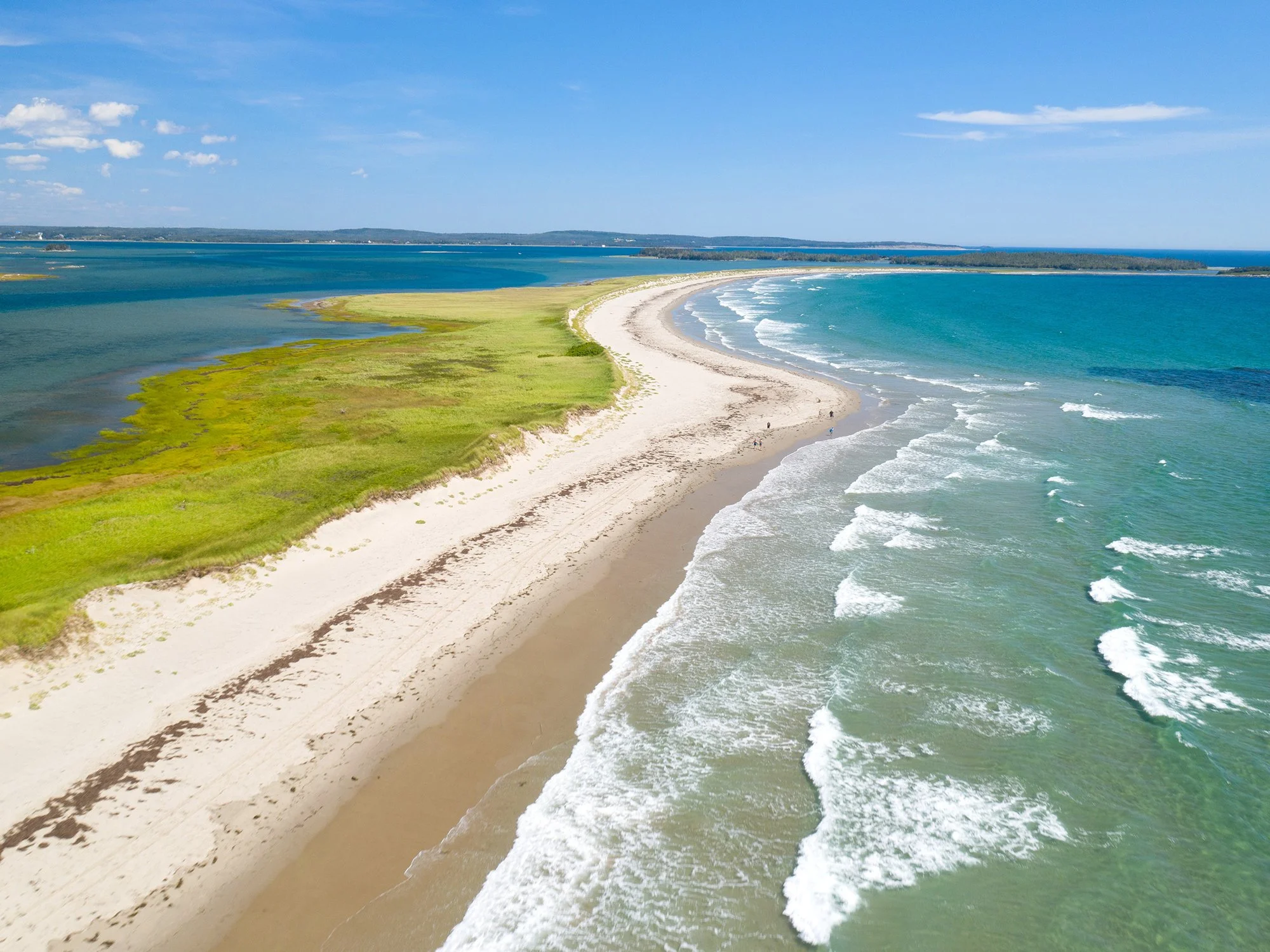 Aerial view of the long sandy shoreline and ocean waves at Martinique Beach near Musquodoboit Harbour.