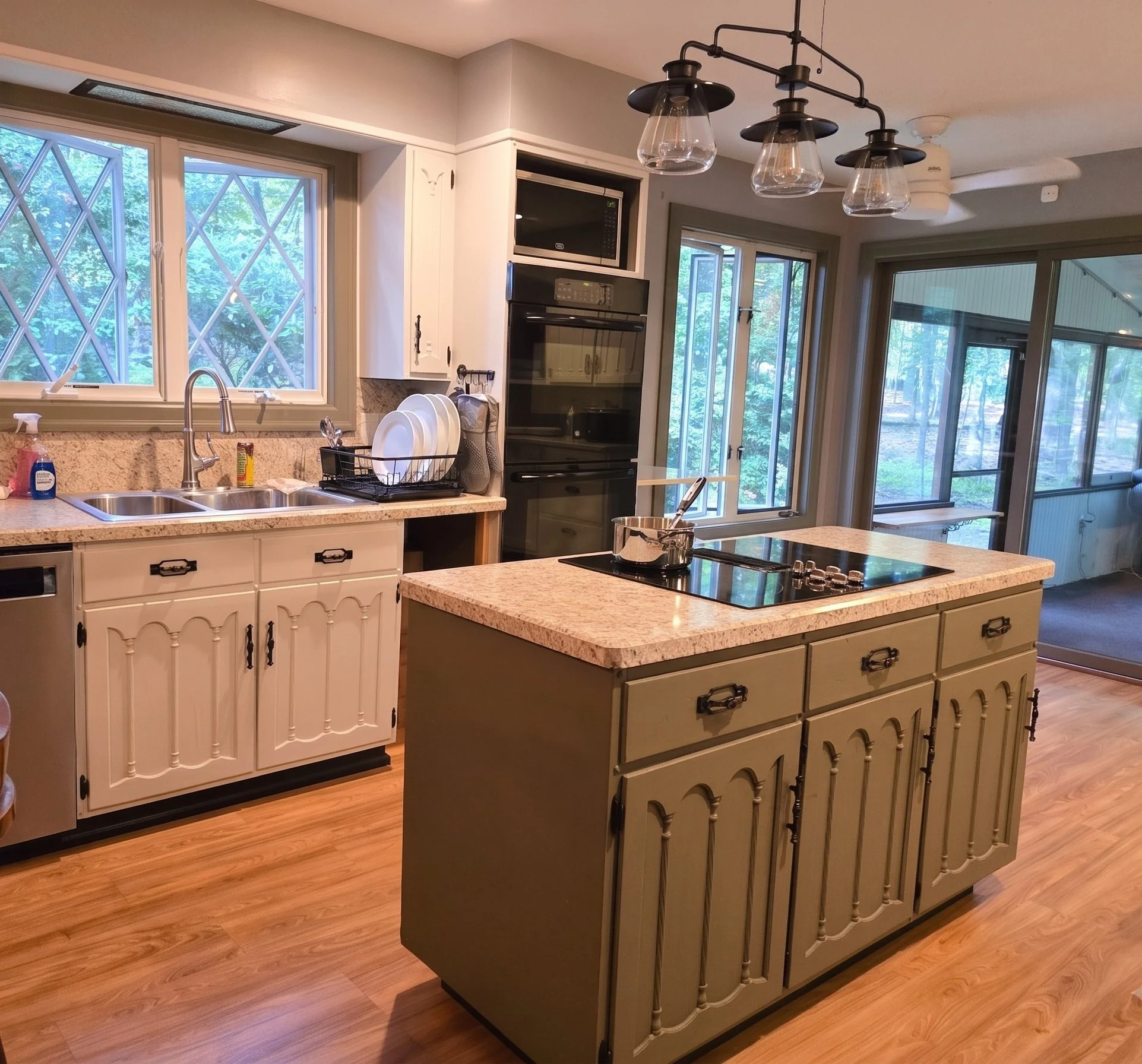 Fully equipped modern kitchen with olive green island, double ovens, and large windows at New Soil Sober Living for men in Northeast Pennsylvania