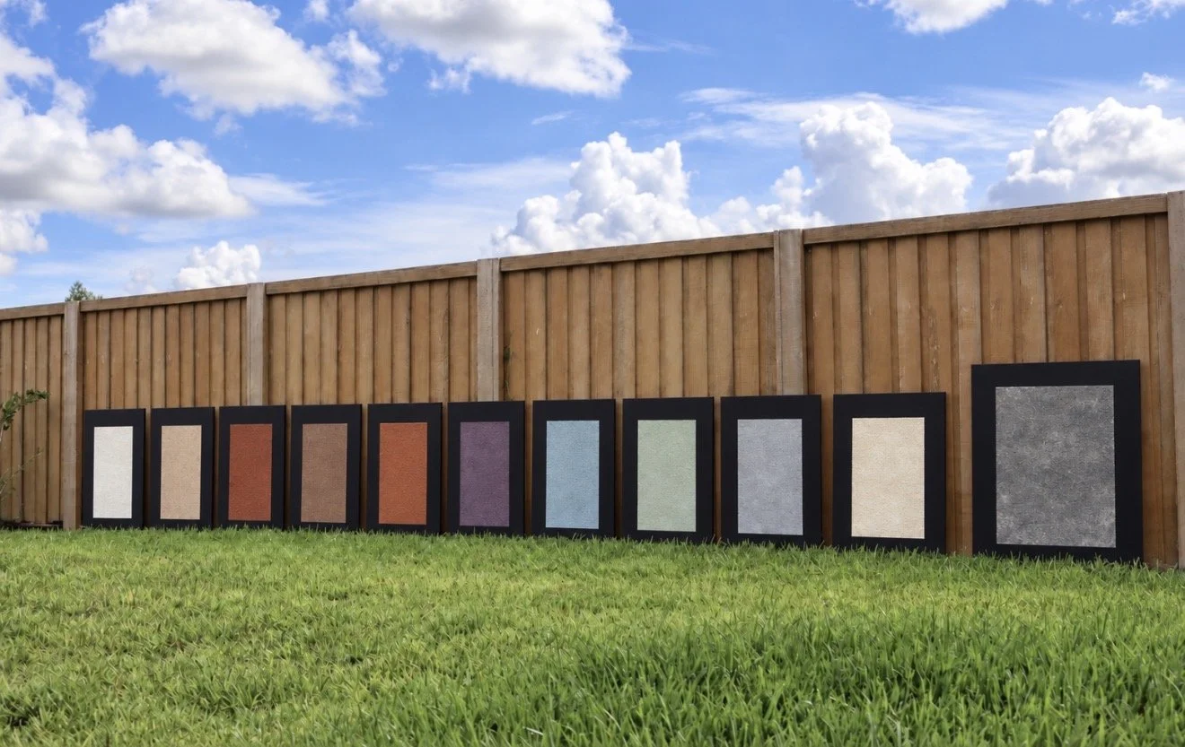 A dense mineral field rests within the depth of black canvas. From a distance, the surface appears grey—quiet, solid, and nearly absolute. Closer observation reveals something less certain: muted traces of violet, green, blue, and earth moving beneat