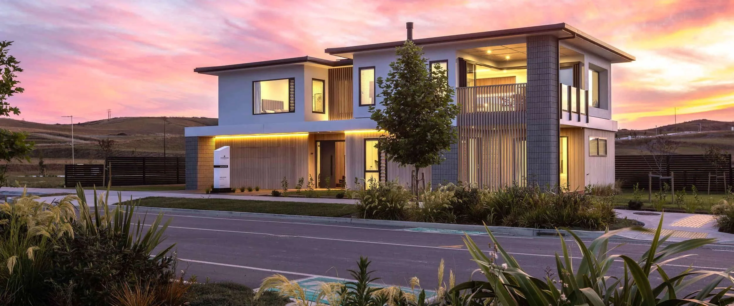 Landmark showhome exterior lit up with LED's and sunset skies