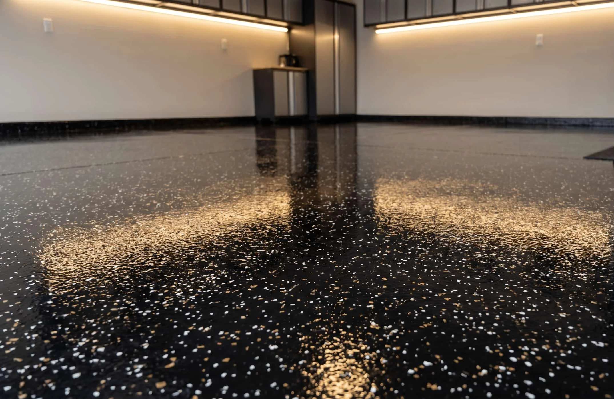 Black epoxy floor with gold and white flakes