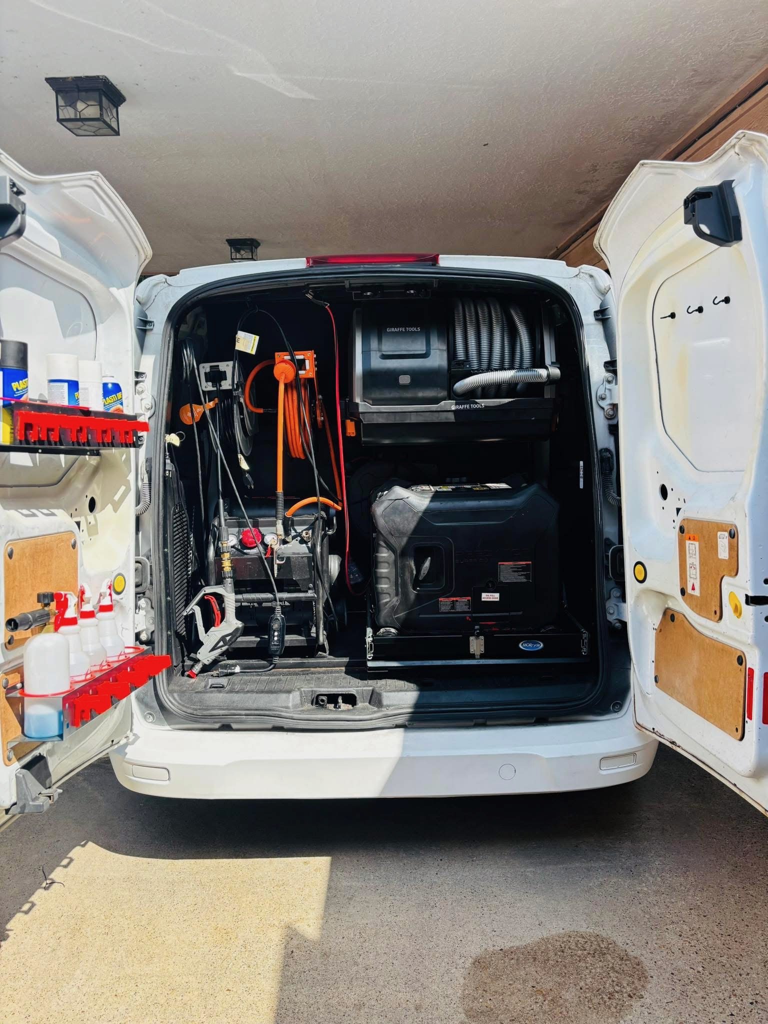 A picture of the back of our fully equiped detailing van with hoses and generator.  -  (NW Houston Diamond Touch Mobile Car Detailing)