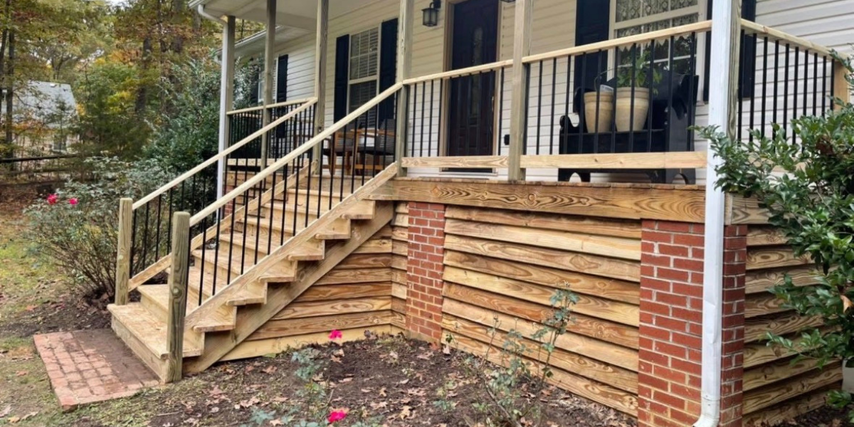 Front porch with new wooden staircase leading up to house, metal railing, and brick and wood siding.