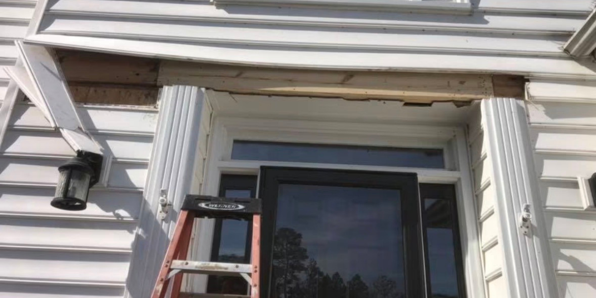 Exterior house wall with siding, window, and a ladder leaning against it during renovation.