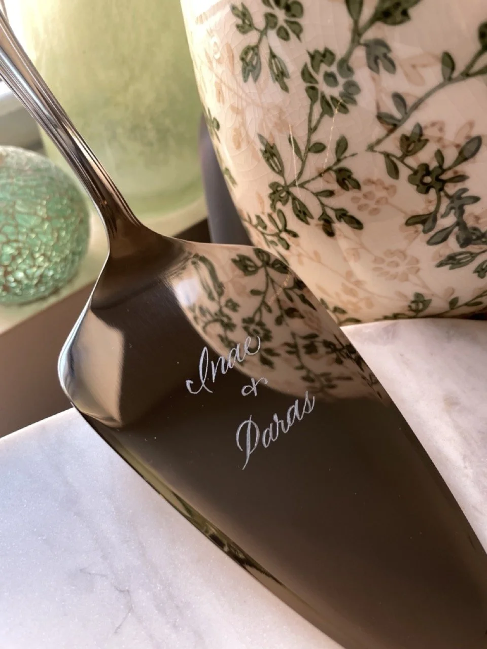 Wedding cake server hand engraved with the couple's names in calligraphy.