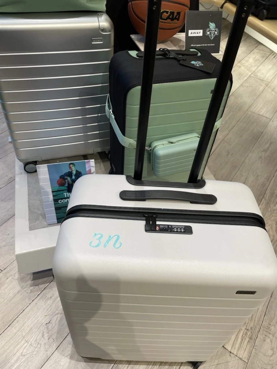 hand painted number and initial on a hard suitcase from Away Travel at a brand activation event