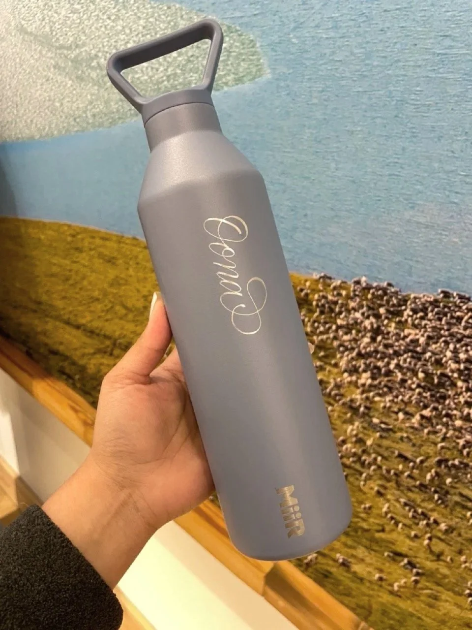 hand engraved name in modern calligraphy on metal MiiR water bottle at a Patagonia fundraising even.