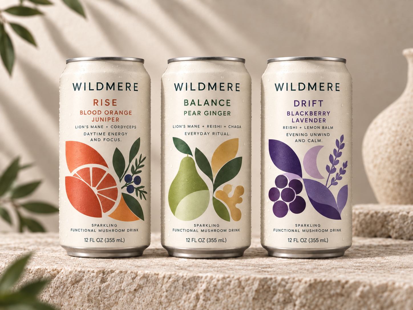 WILDMERE Rise Blood Orange Juniper, Balance Pear Ginger, and Drift Blackberry Lavender concept cans.