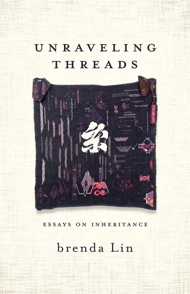 Book cover titled "Unraveling Threads: Essays on Inheritance" by Brenda Lin, featuring a black embroidered fabric square with pink, purple, and red patterns and a white Chinese character in the center.