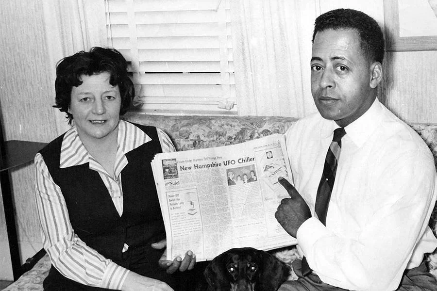 Barney and Betty Hill Posing in Front of a Newspaper Article