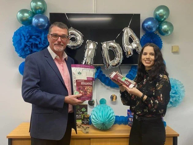 Joe Foster at an industry event with packaged food products