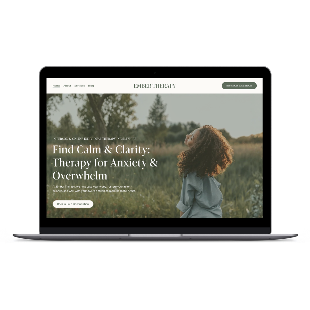 Laptop displaying a therapy services website with a woman outdoors, greenery, and a serene landscape.